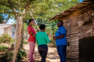 2022_Africa_Male monitor talking to two females in the village about human trafficking_CS (1)