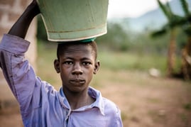 africa_young_boy_carrying_bucket