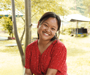 Girl outside in red dress smiling