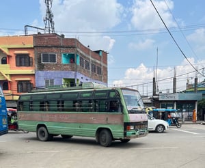 Green bus near a border crossing in Asia