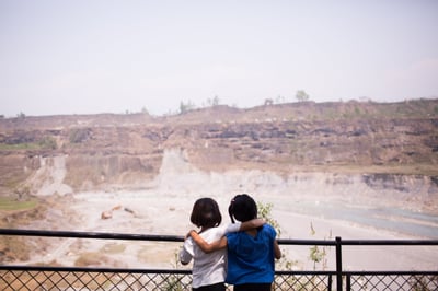 two girls from behind with arms around each other