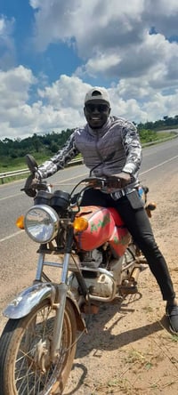 Peter uganda monitor on bike
