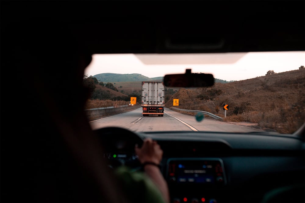 POV driver, following a truck through rural area