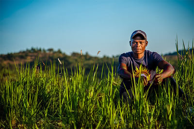 african man sitting in grass