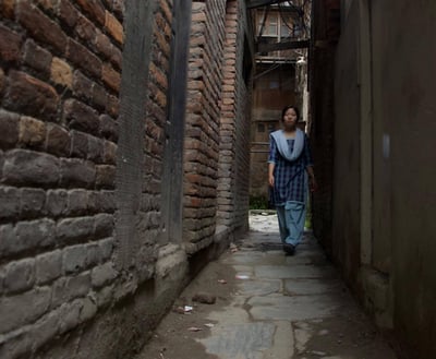 asian girl walking in alley