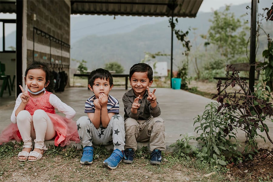kids in the school sitting outside
