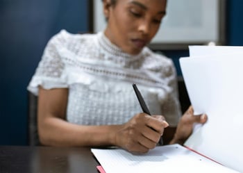 girl signing papers pexels