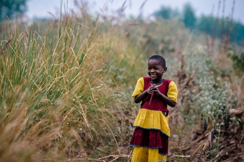 little african girl in a red and yellow dress