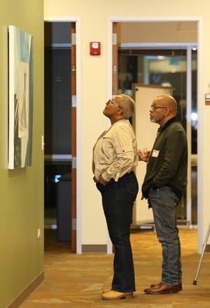 people looking at art exhibit