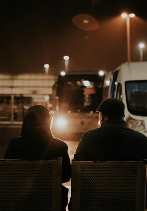 two-ppl-on-bench-bus-station-2