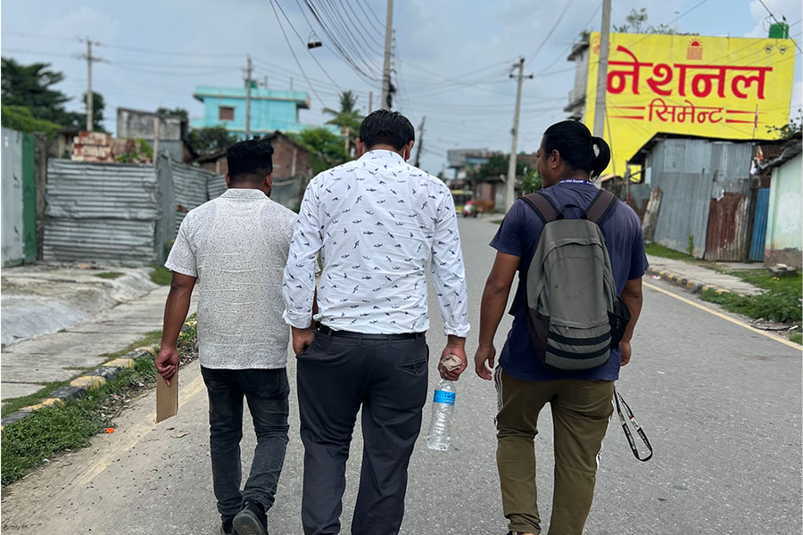 Monitors walk near a border looking for potential trafficking victims.